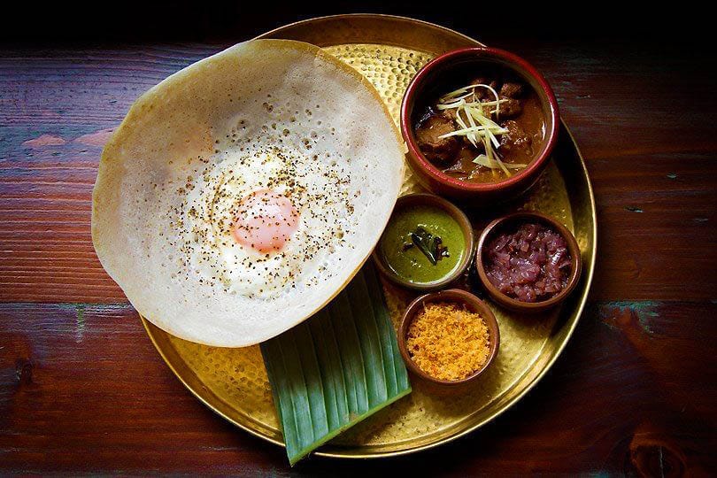 Egg Hopper & Lamb Kari Pol Sambol, Seeni Sambol, & Coriander Chutney at Hoppers London