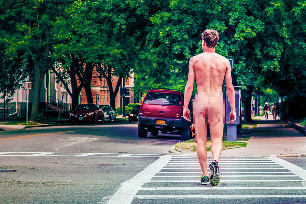 Fearless man walking across the street naked challenging adversity